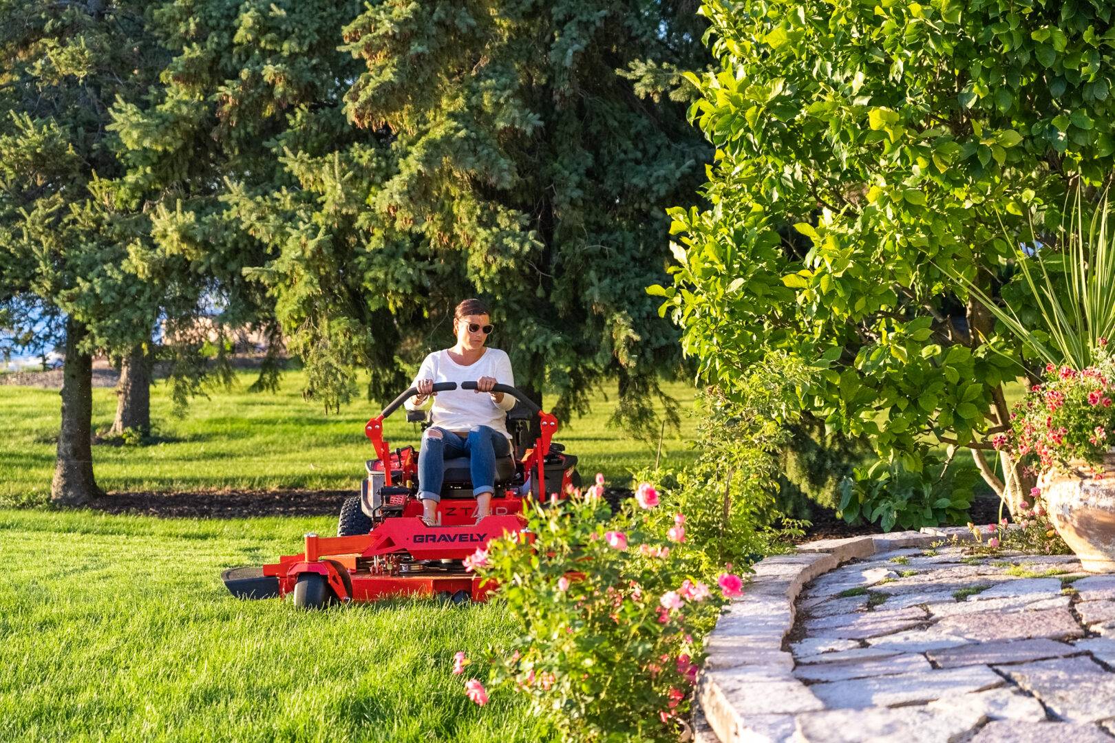 Complex Garden Mowing with Riding Mower Man navigating a riding mower through complex garden layouts.