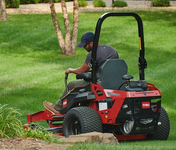 Outdoor Lawn Mowing with Riding Mower Man performing routine lawn maintenance with a riding mower.